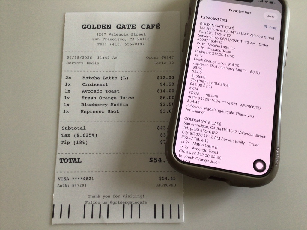A paper café receipt next to an iPhone showing the extracted text from OCR